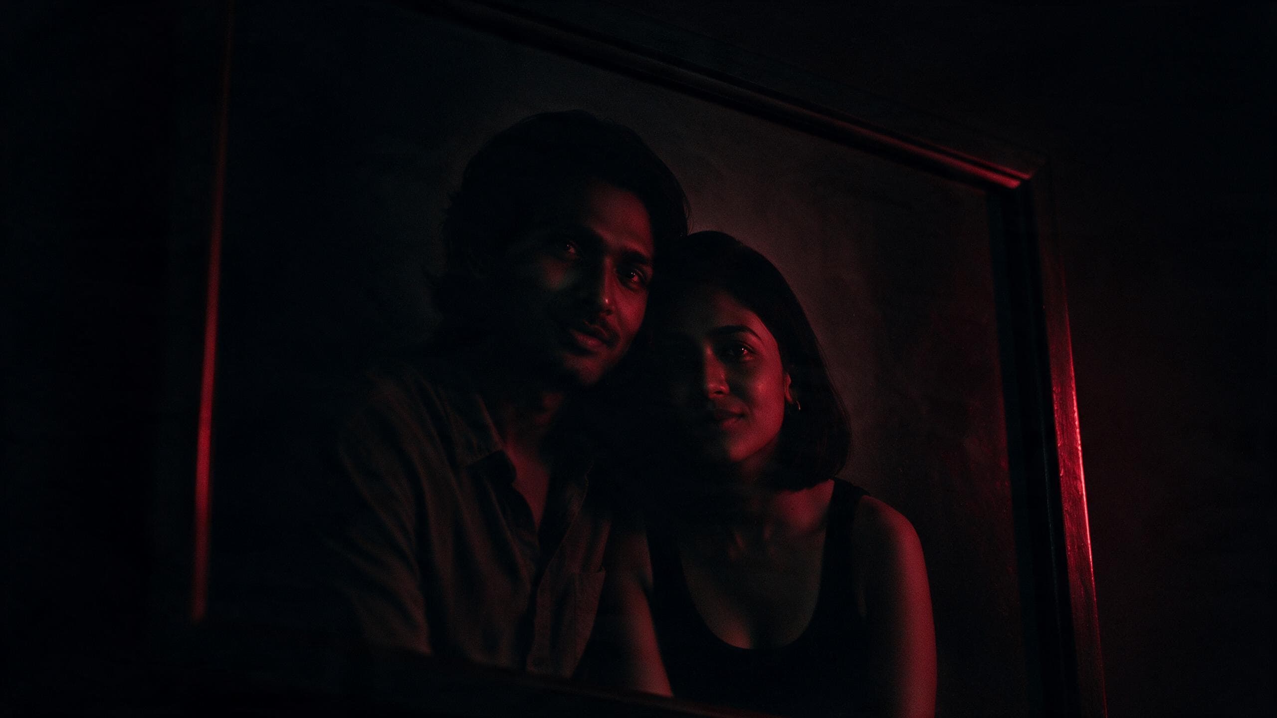 A dim framed portrait of a couple